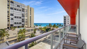 A hotel with a pool, beach view, and a red awning. - Luxury Beach Condo with Partial Ocean View -CS15 (Hollywood)