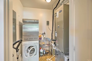 Convenient laundry facilities include a washer, dryer, refrigerator, and sink.