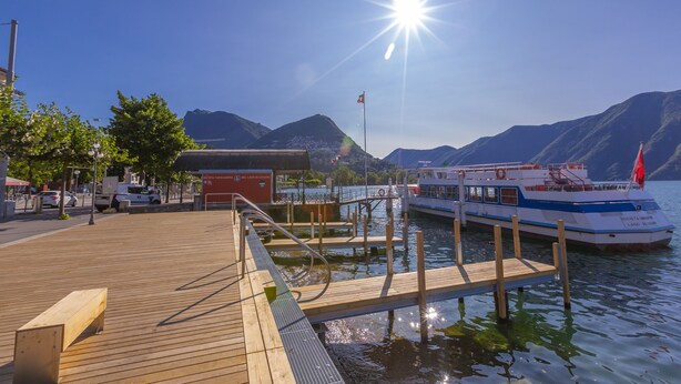 A wooden dock extending into calm water with a boat docked at the end. - ICON H Lugano 306 Suite Micro-Living, Lugano, Switzerland (Lugano)