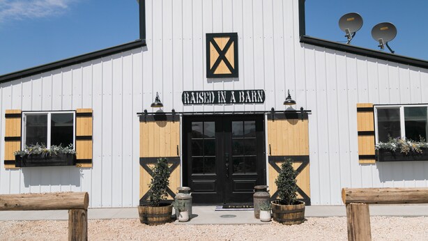 A barn-style building with a sign reading "Raised in a Barn." - Barn  Stay (Hurricane)