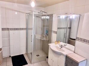 Shower, hair dryer, towels, toilet paper