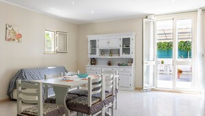 A dining area with a table, chairs, and a cabinet with glass doors.
