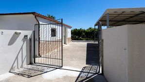 A gated entrance to a building with a clear sky above.