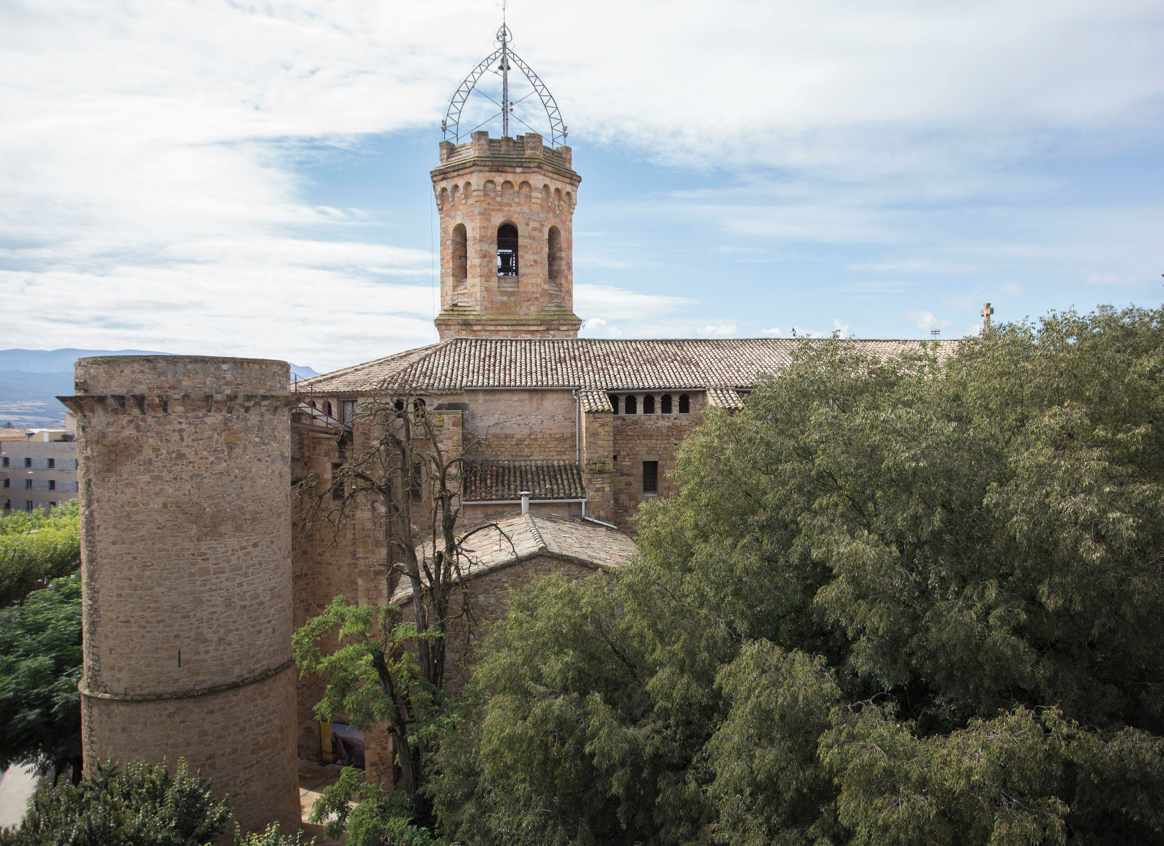 A historic building with a prominent bell tower and a large stone tower.
