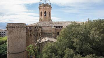 A historic building with a prominent bell tower and a large stone tower.