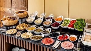 A buffet with various food items including fruits, vegetables, and meats. - Kutaisi Inn (Kutaisi)