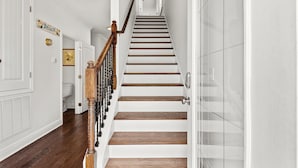A staircase with wooden steps and a wooden handrail, leading to an upper floor. - Amazing Inlet Beach, Shopping and Dining: Blue Mar + Free Attraction Tickets! (Inlet Beach)