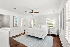 A bedroom with a bed, nightstands, a ceiling fan, and a window with blinds. - Amazing Inlet Beach, Shopping and Dining: Blue Mar + Free Attraction Tickets! (Inlet Beach)