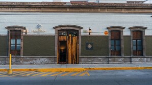 A building with a large wooden door, a sign reading "CASA TEQUIS," and a street lamp. - Hotel Casa Tequis San Luis Potosi (San Luis Potosi)