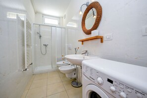 Een douche, een haardroger, een bidet, handdoeken