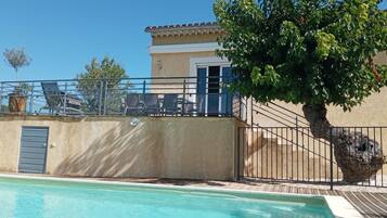 Enjoy a refreshing dip in the pool from the comfort of your balcony overlooking a serene garden.