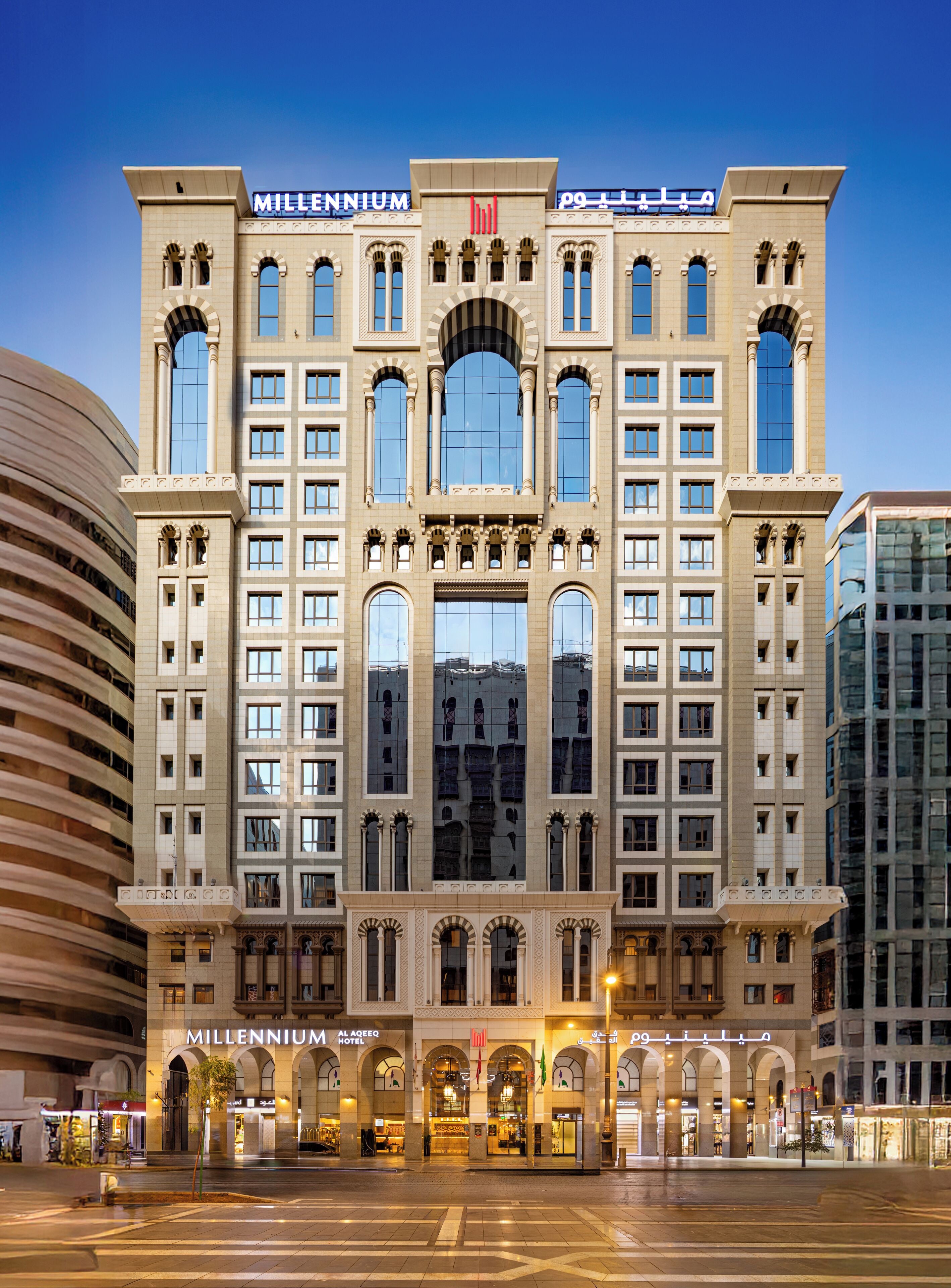 A large, multi-story hotel with arched windows and a central entrance.
