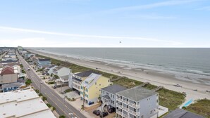 Une ville côtière avec une plage, des maisons et une route.