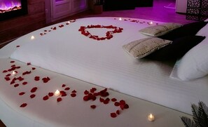 Experience a romantic getaway in this inviting room with a large bed, fireplace, and thoughtful touches.
