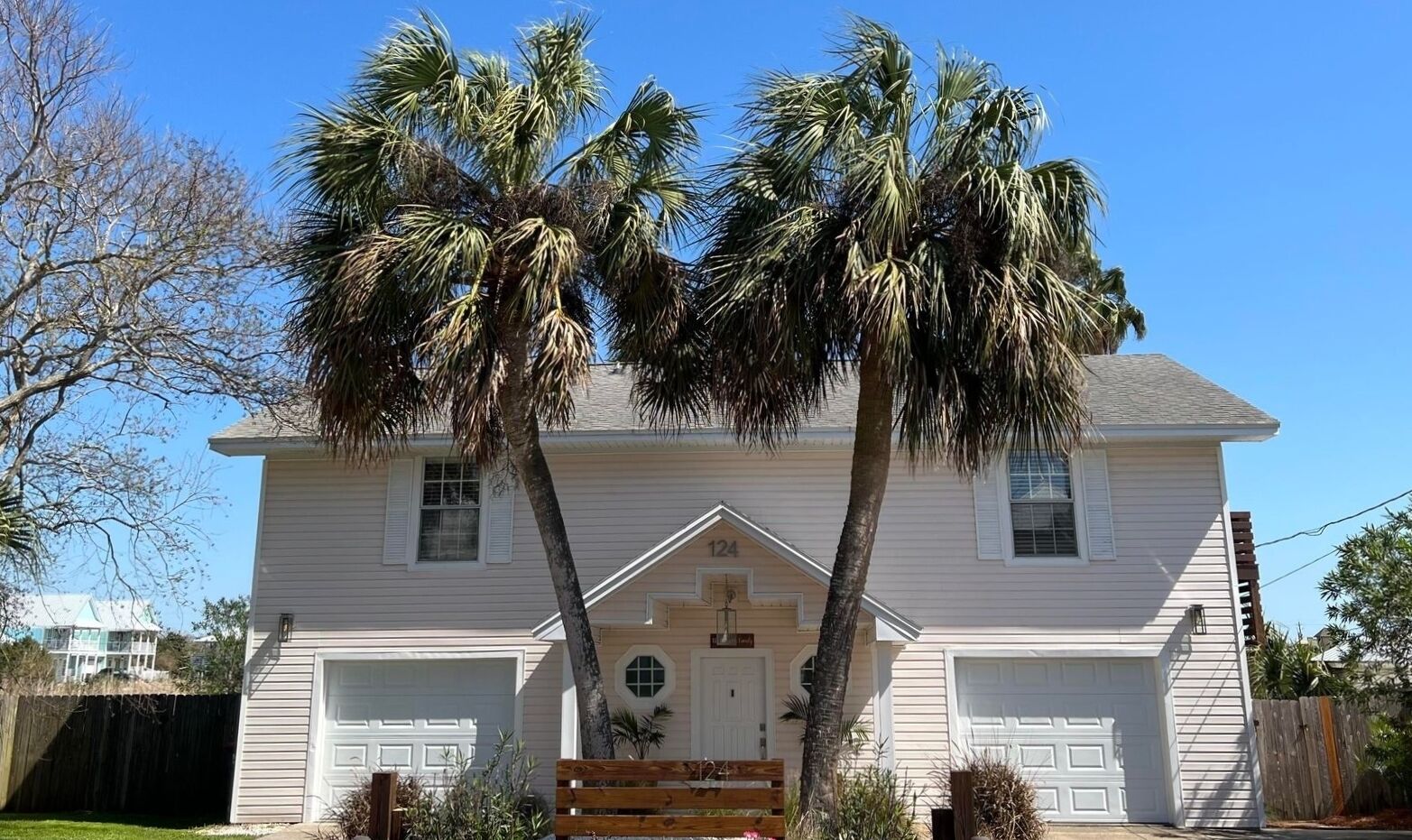 A two-story house with a front porch, a garage, and a number '124' on the front.