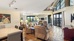 A spacious living area with a dining table, sofas, and a ceiling fan. - Top floor amazing view Toms Chicken Coop awaits your next stay. Best value (Key West)