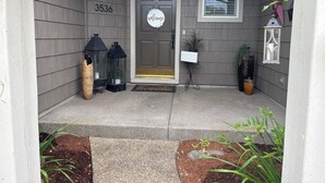 A house entrance with a number '3536' above the door, a 'welcome' sign, two lanterns, and a potted plant. - 5 Miles from Hayward field (Eugene)