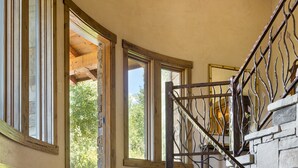 A stone staircase with a wrought iron railing leading to an upper level. - Outpost: Teton Retreat - Expansive Teton Views (Jackson)