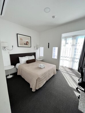 Deluxe Room | Down comforters, desk, laptop workspace, blackout drapes