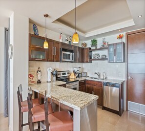 Family Condo | Private kitchen | Fridge, dining tables