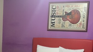 A bed with a red headboard, white pillows, and a white blanket. - The Cottage (Kingston)