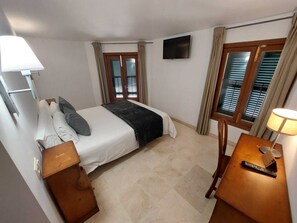 Enjoy a comfortable stay in this well-appointed room featuring a king-size bed, television, and desk with lamp.