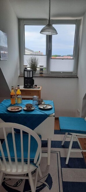 Enjoy meals for two in this cozy dining area with a table, chair, and scenic view.
