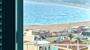 A coastal view with buildings and parked cars. - N254 - Numana, sky-earth with a wonderful garden overlooking the sea (Numana)