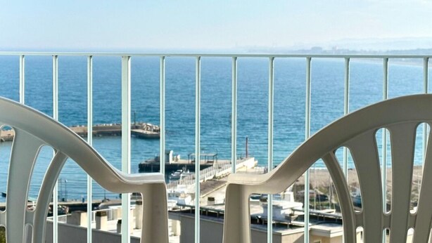 A balcony with white chairs overlooking a coastal view. - N254 - Numana, sky-earth with a wonderful garden overlooking the sea (Numana)