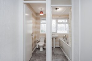 A bathroom with a toilet, sink, and bathtub. - Tms Lovely 3 Bed House-tilbury-free Parking (Tilbury)