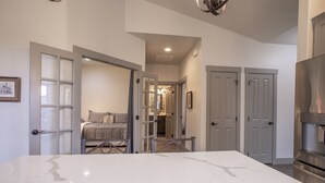 A modern kitchen with a marble countertop, a built-in oven, and a stainless steel refrigerator. - Perfect Golf Getaway near Glacier, 2/2 townhome right on golf course (Kalispell)