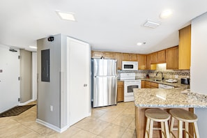 Enjoy cooking in this well-equipped kitchen with a refrigerator, microwave, and stove.