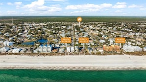 An aerial view of a coastal residential area with multiple houses and a beach. - Comforts of home and just a 5 min walk to the beach! Plus private pool (Panama City Beach)