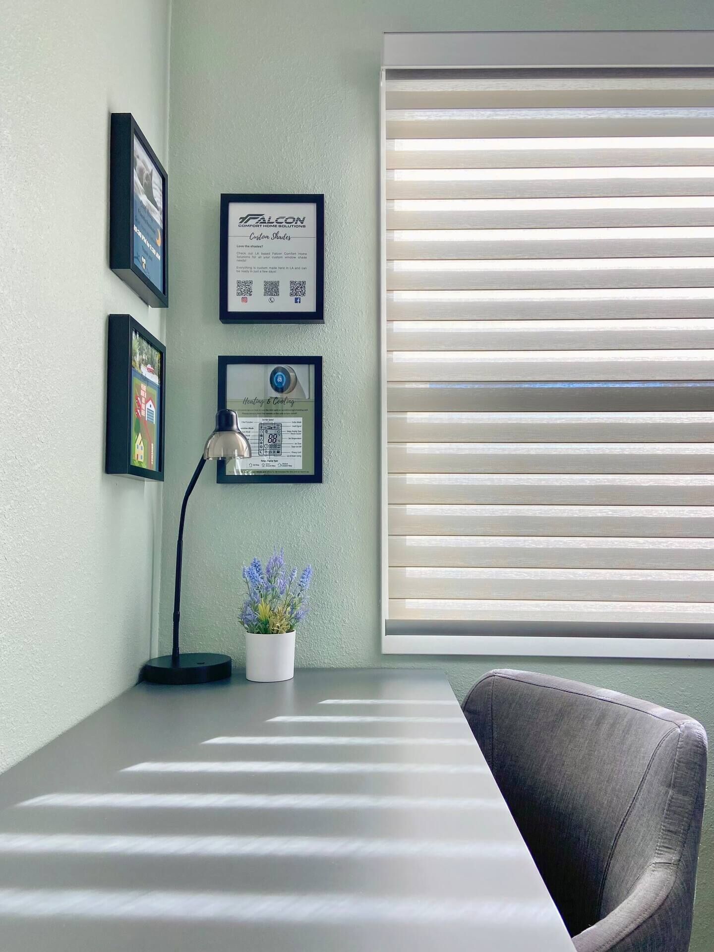A room with a desk, a chair, a potted plant, and a window with blinds.