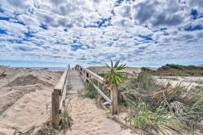 A wooden boardwalk leading to a beach with dunes and sparse vegetation. - The Mark at Surfside, Apt. 1 (Surfside Beach)