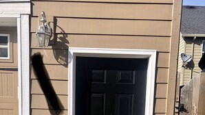 A house with a dark front door, a mailbox, and a small porch area. - Private, comfy and cozy apartment in family neighborhood (Oregon City)