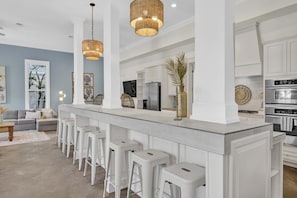 Enjoy a sleek and functional kitchen with a central island and comfortable dining area.