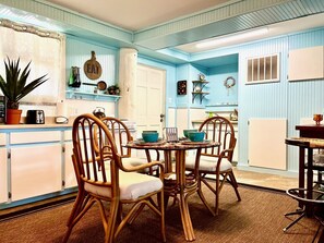 Cozy kitchen with a central table and four chairs, perfect for mealtime gatherings.