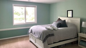 A bedroom with a bed, a nightstand, a window, and a ceiling light. - Water view high bank two bedroom private border Manchester State Park. (Port Orchard)