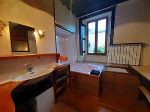 Bathtub, towels, soap, toilet paper