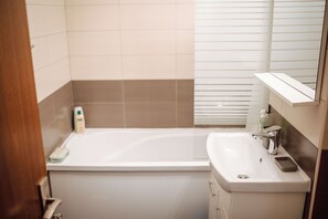 Combined shower/bathtub, eco-friendly toiletries, hair dryer, bathrobes