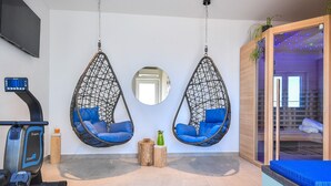 A room with two hanging chairs, a treadmill, a mirror, and a sauna area. - Beautiful peaceful villa with a pool in the center of Dubrovnik (Dubrovnik)