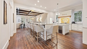 A spacious kitchen with a large island, bar stools, and a built-in oven. - Gorgeous 2nd row home directly on the beach path in Palmetto Dunes with pool (Hilton Head Island)