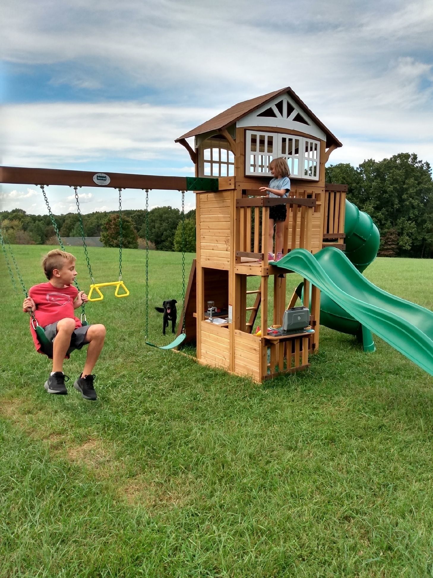 Cozy cabin with fire pit, hot tub, and pool, and a swing set in the backyard!
