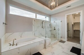 Bathtub, hair dryer, towels, shampoo