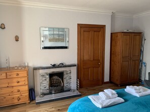 Un dormitorio con chimenea, armario de madera y cama con toallas.