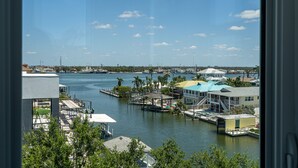 A marina with docked boats, a waterway, and buildings with a dockside restaurant.