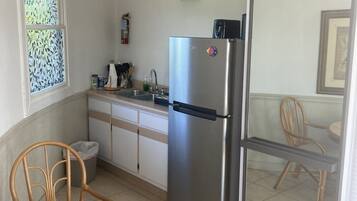 Full-sized fridge, stovetop, cookware/dishes/utensils, cleaning supplies