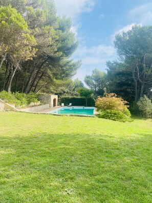 A swimming pool surrounded by a grassy lawn and trees. - Luberon - LOVELY HOUSE sixteenth century overlooking the valley (MERINDOL)