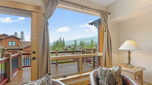 A room with a wooden deck, a view of mountains, a wooden railing, and a lamp on a side table. - Townhome w/ Private Saltwater Hot Tub Near Keystone Ski Village (Keystone)